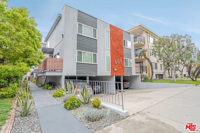 a view of a house with a bench in a patio