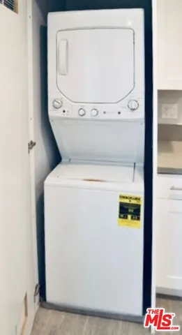 a kitchen with a sink cabinets stainless steel appliances and a window