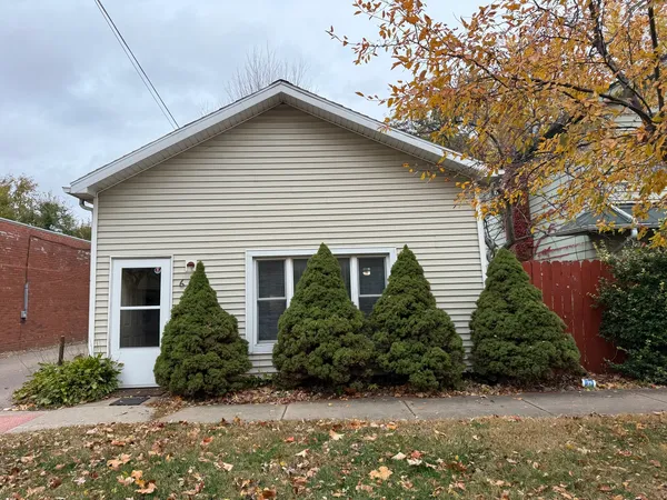 a view of a house with a yard and plants