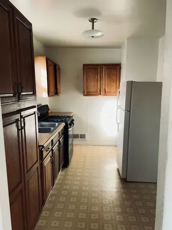 a kitchen with stainless steel appliances granite countertop a refrigerator a stove and a refrigerator