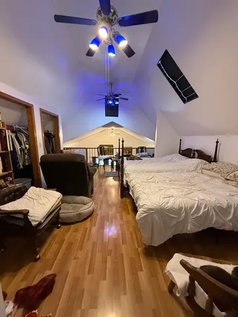 a bedroom with bed and a chandelier