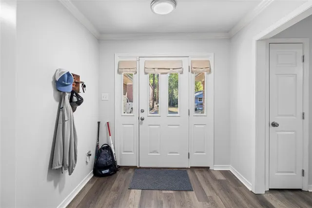 a view of a room with wooden floor and a ceiling fan