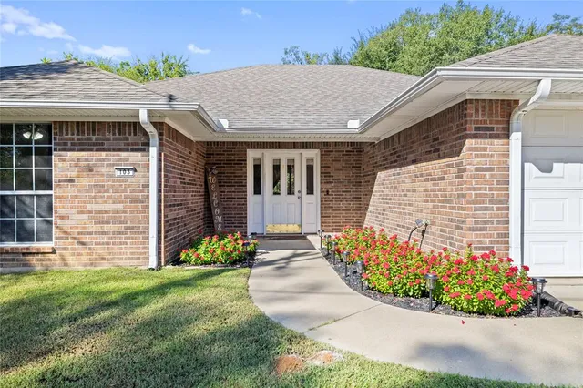 a view of a house with a yard and garden
