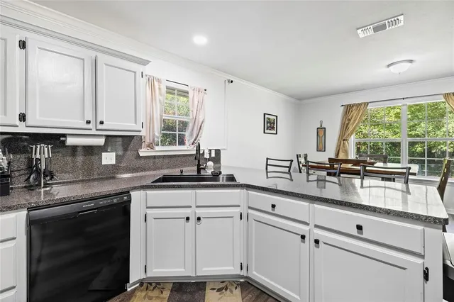 a kitchen with granite countertop white cabinets and white appliances