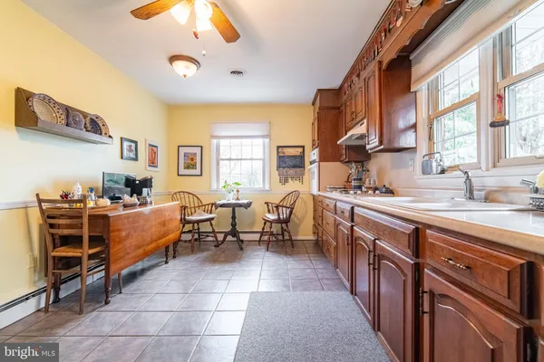 a kitchen with kitchen island granite countertop lots of counter top space and stainless steel appliances