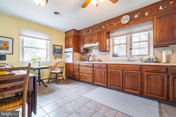 a kitchen with cabinets a sink and appliances