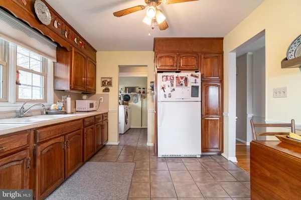 a kitchen with refrigerator cabinets and a sink