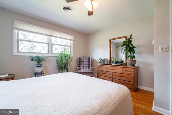 a bedroom with a large bed and a dresser