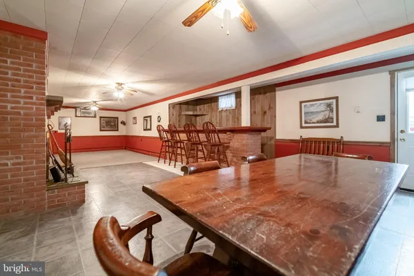 a living room with dining room and wooden floor