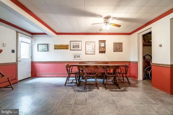 a living room with furniture a dining table and chairs