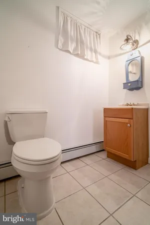 a bathroom with a toilet and a mirror