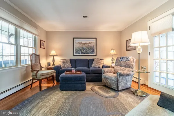a living room with furniture a table and a large window