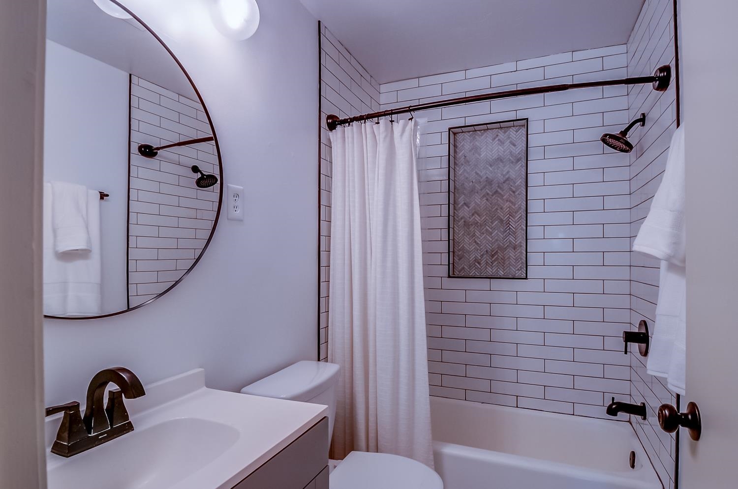 5056 Wingdale Road Memphis, TN 38117 - Photo 17 of 18 Bathroom featuring vanity and shower / bath combination with curtain
