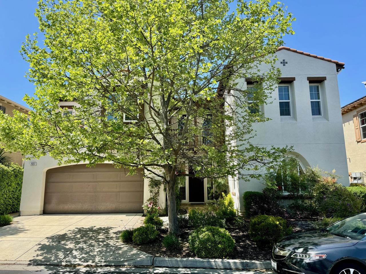 a front view of a house with trees