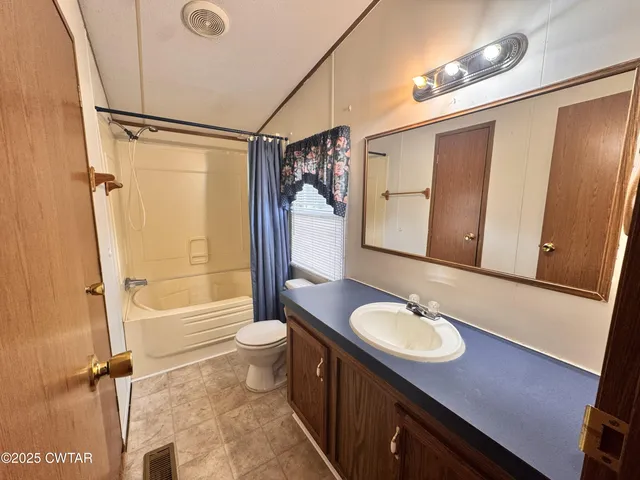 a bathroom with a sink a toilet a mirror and shower