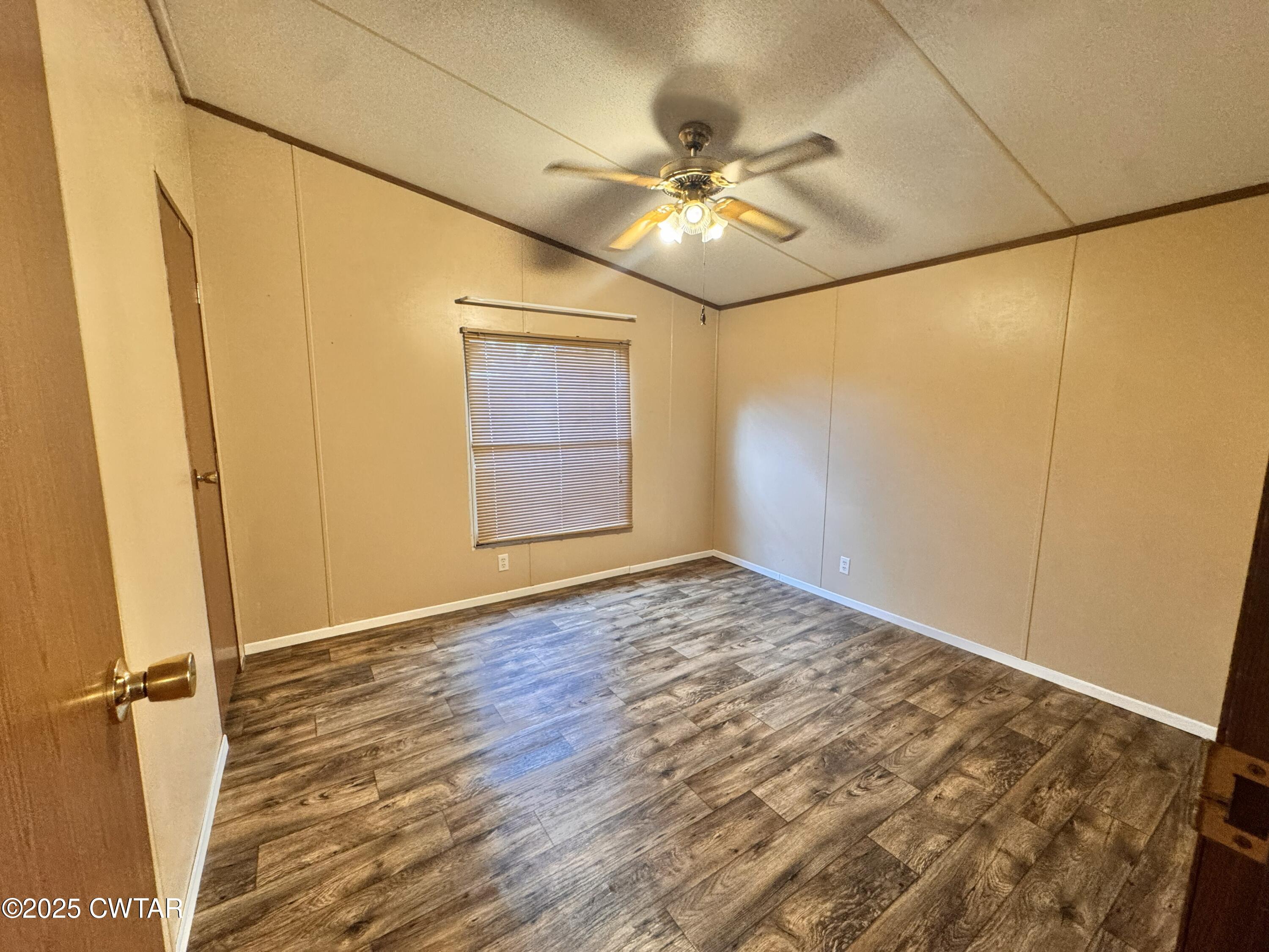 3416 West Troy Street Rives, TN 38253 - Photo 12 of 21 an empty room with wooden floor and fan