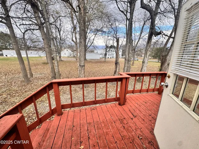 a view of balcony with wooden floor and fence