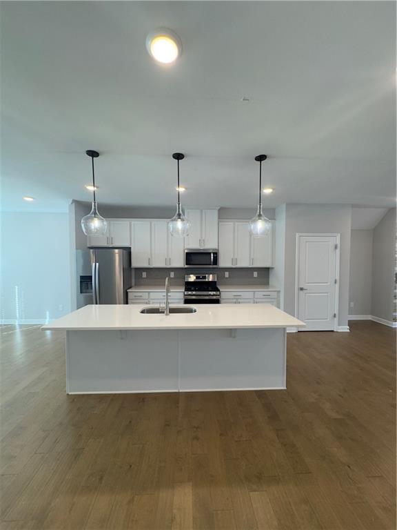 20 Wren Drive Roswell, GA 30076 - Photo 14 of 37 a large white kitchen with a sink and dishwasher a stove top oven with wooden floor