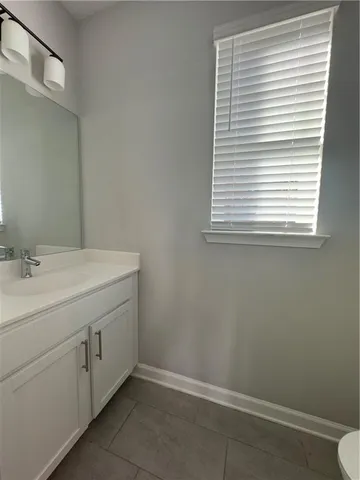 a room with a sink cabinets and a window