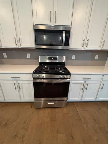 a stove top oven sitting inside of a kitchen