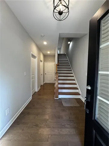 a view of entryway and hall with wooden floor