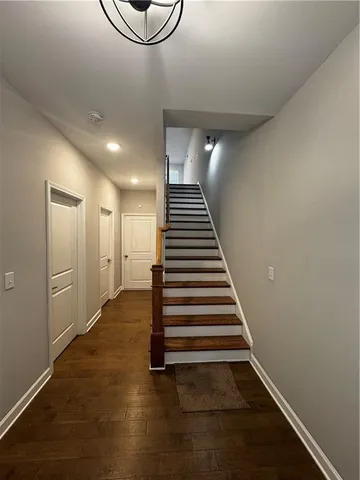 a view of a room with wooden floor and stairs