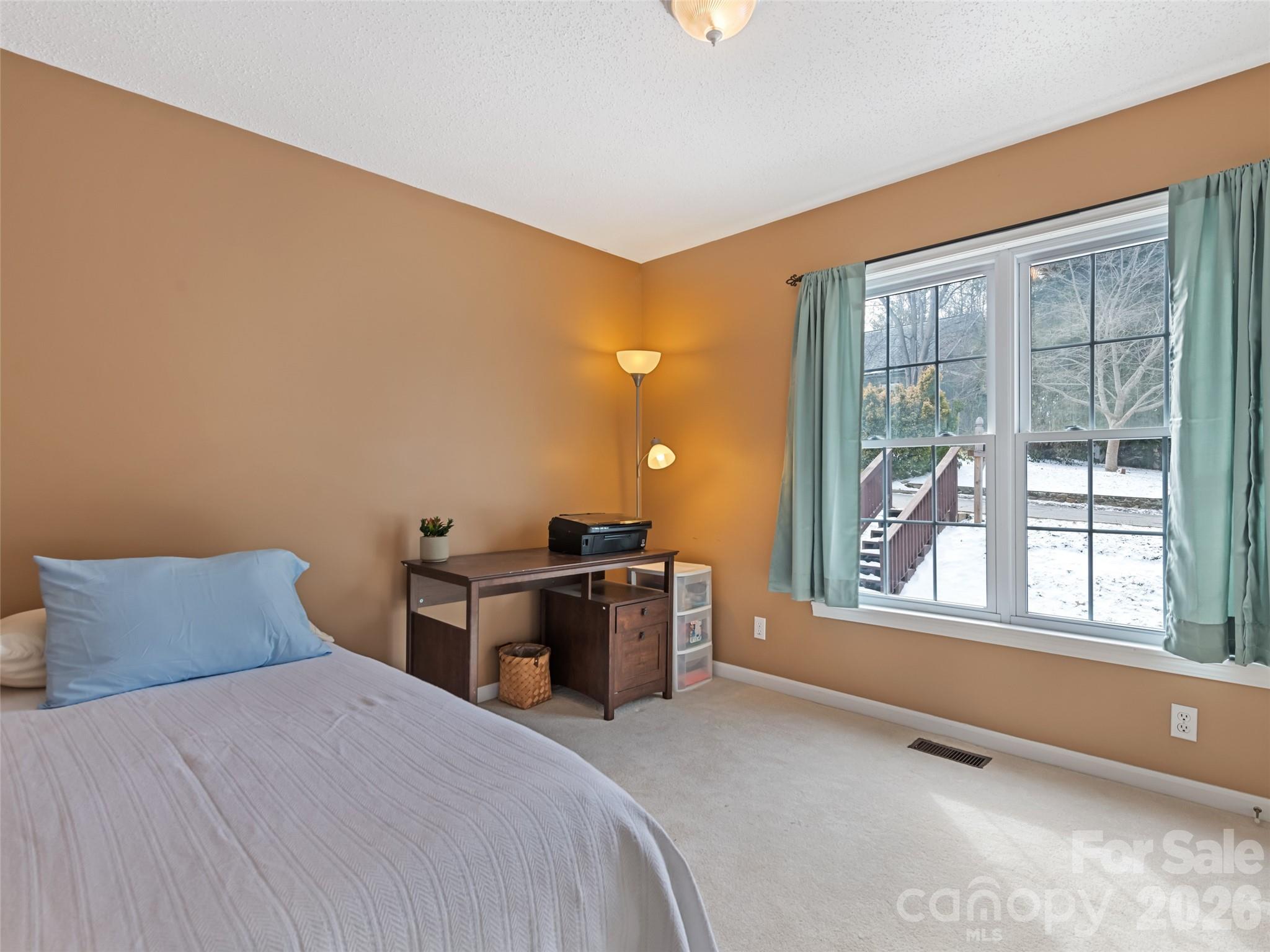 30 Woodruff Street Canton, NC 28716 - Photo 11 of 16 a bedroom with a bed and a large window with outer view