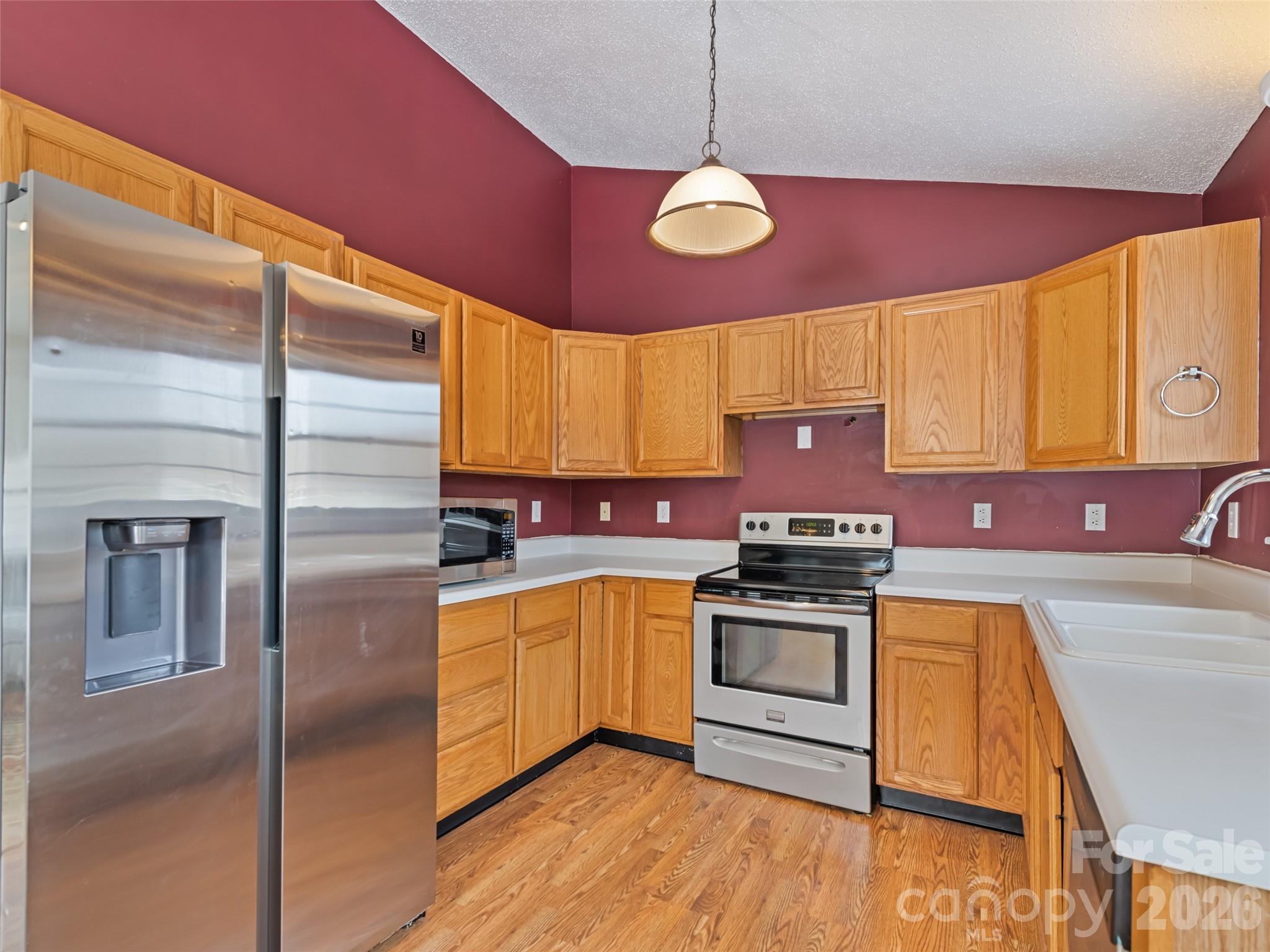 30 Woodruff Street Canton, NC 28716 - Photo 6 of 16 a kitchen with stainless steel appliances granite countertop a sink a stove and refrigerator