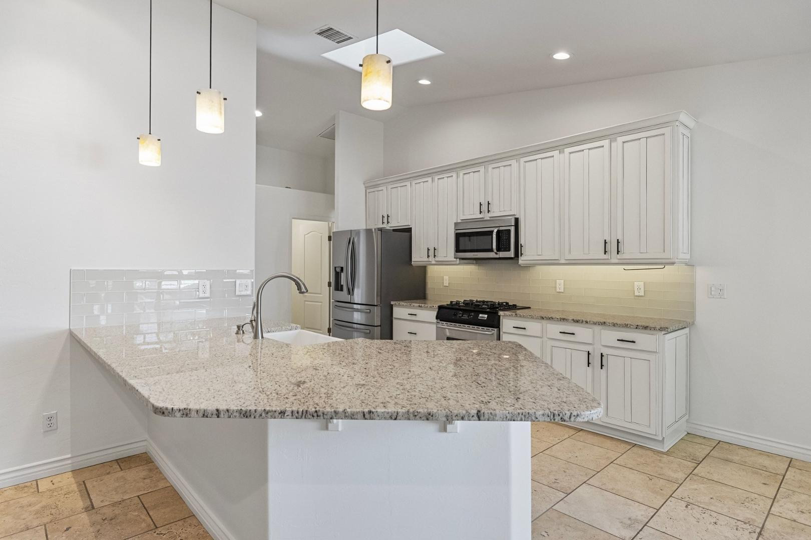 5233 North 15th Street Phoenix, AZ 85014 - Photo 19 of 55 a kitchen with granite countertop a sink a counter space appliances and cabinets