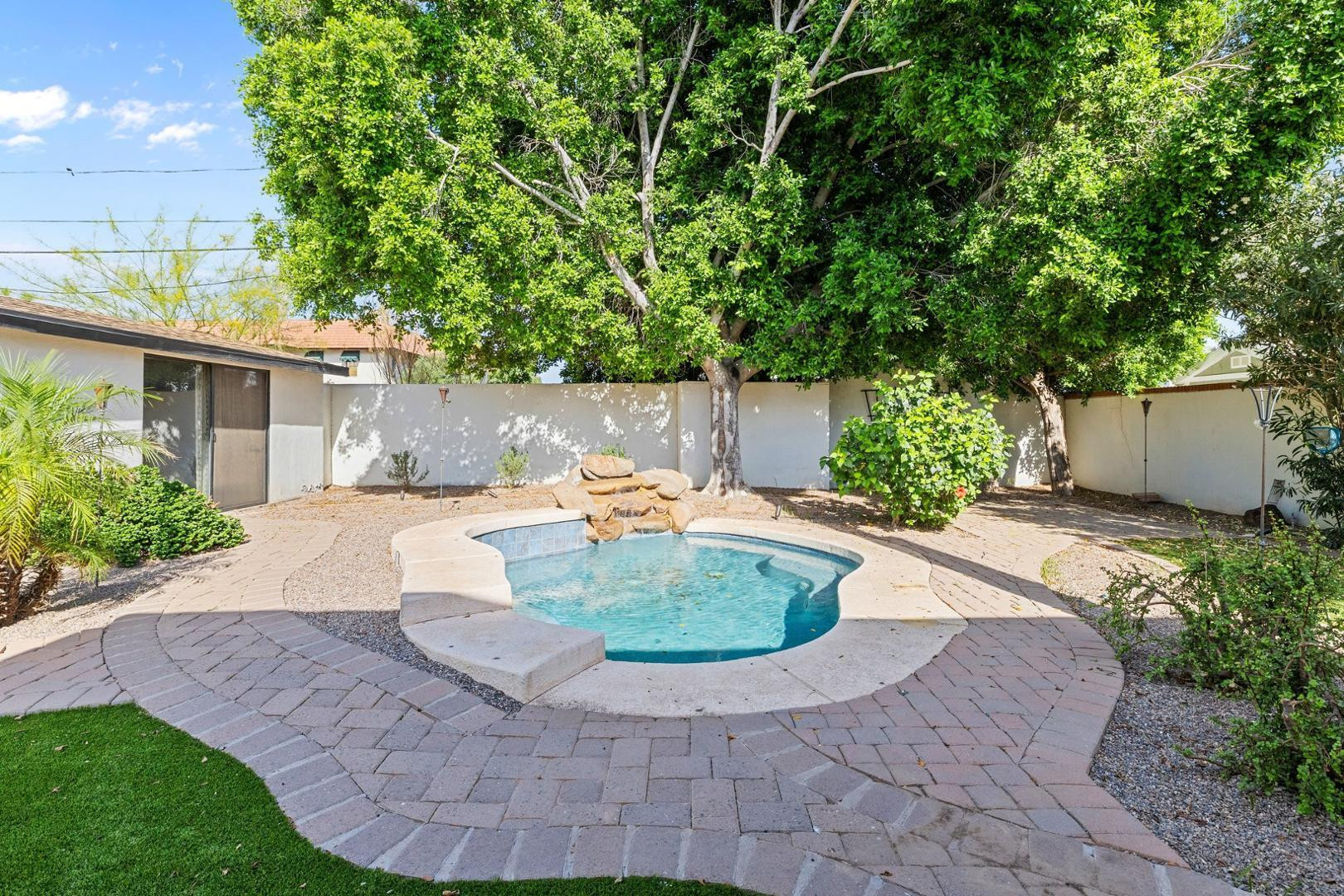 5233 North 15th Street Phoenix, AZ 85014 - Photo 42 of 55 a view of a backyard with potted plants and large trees