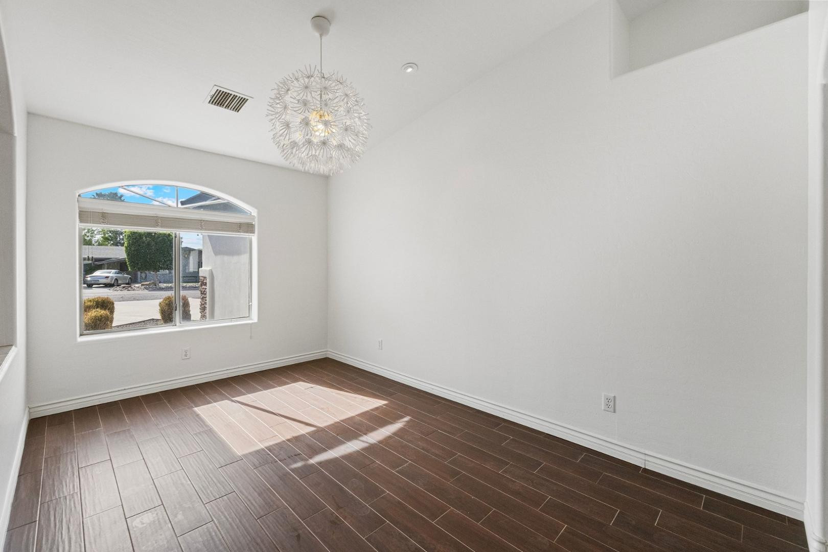 5233 North 15th Street Phoenix, AZ 85014 - Photo 7 of 55 wooden floor in an empty room with a window