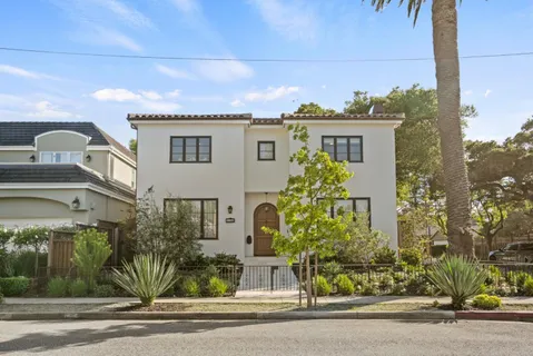 a front view of a house with a garden