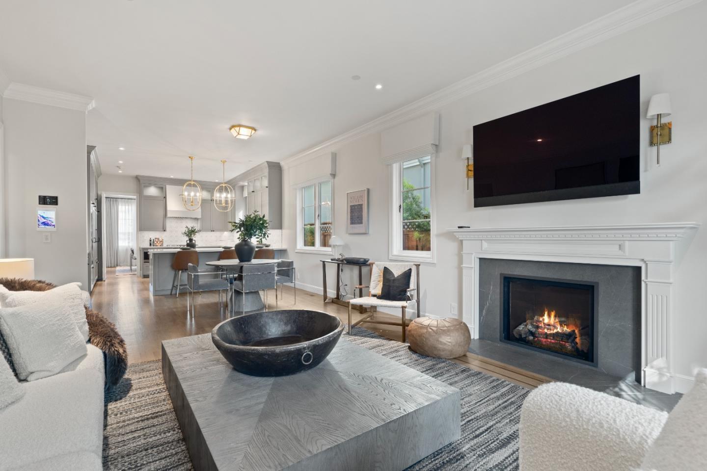 1153 Cabrillo Avenue Burlingame, CA 94010 - Photo 21 of 80 a living room with furniture a flat screen tv and a fireplace
