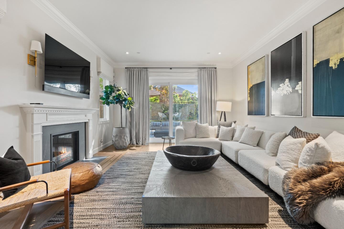 1153 Cabrillo Avenue Burlingame, CA 94010 - Photo 24 of 80 a living room with furniture a flat screen tv and a fireplace