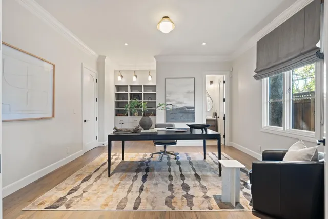 a bedroom with a bed a chandelier and chair