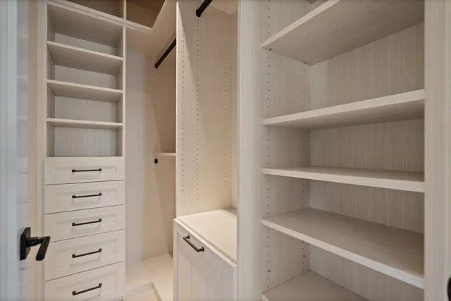 a view of a backyard with couches plants and large trees