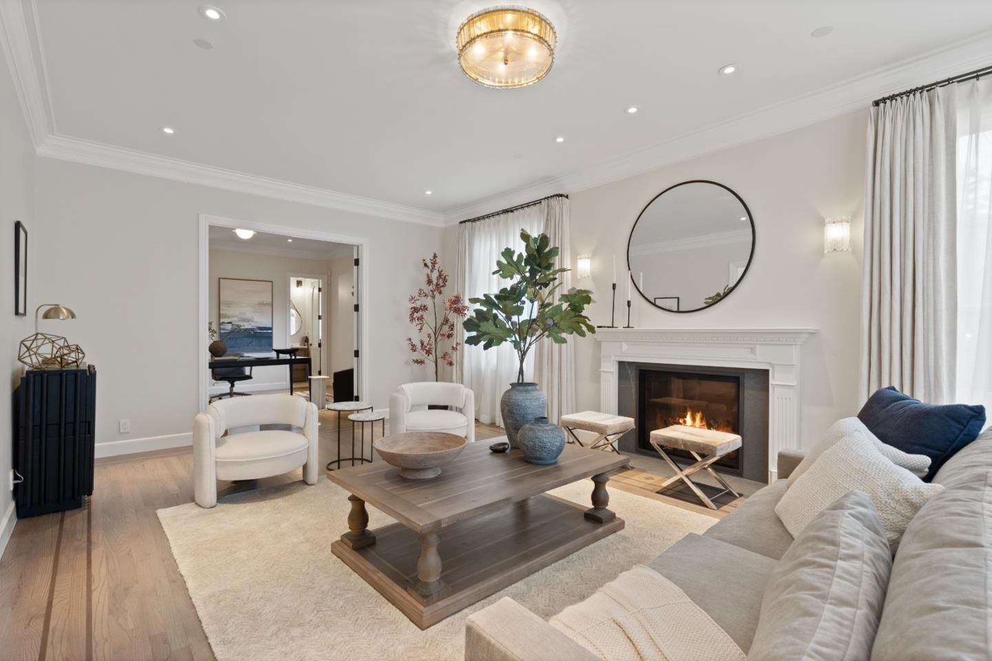 1153 Cabrillo Avenue Burlingame, CA 94010 - Photo 7 of 80 a living room with furniture a fireplace and a potted plant