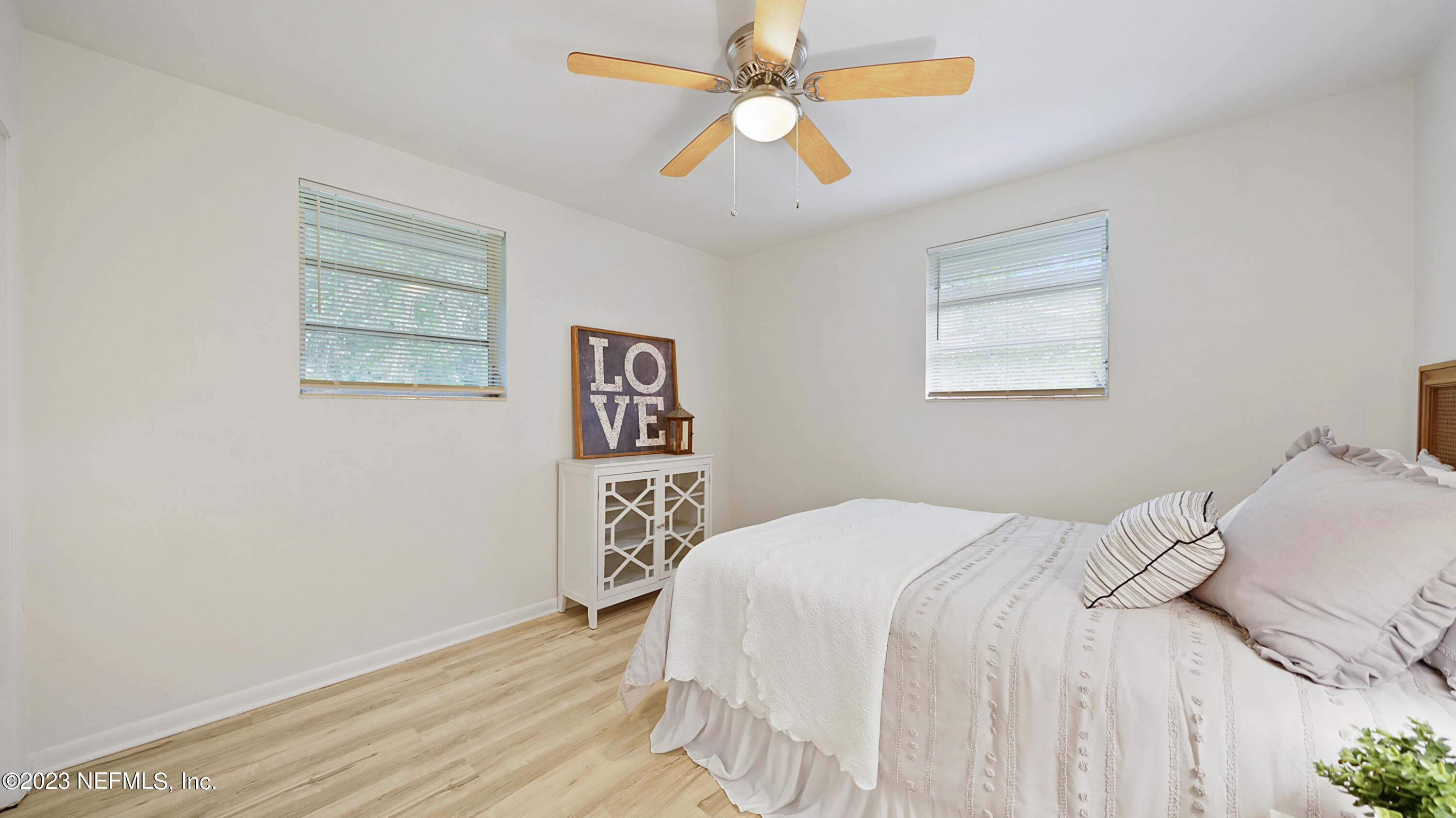 1130 Labelle Street Jacksonville, FL 32205 - Photo 16 of 24 a bedroom with a bed and a chandelier