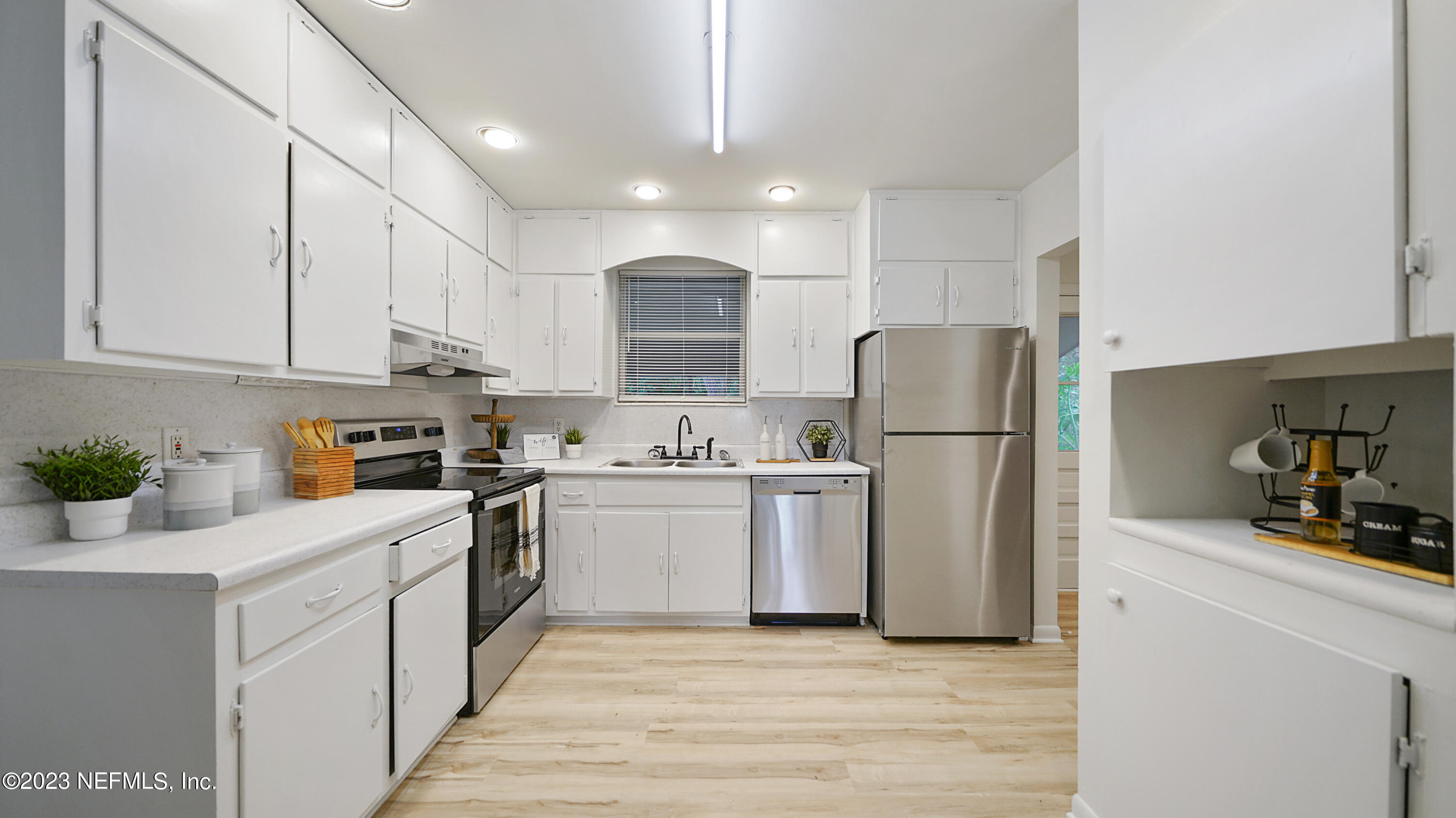 1130 Labelle Street Jacksonville, FL 32205 - Photo 5 of 24 a kitchen with white cabinets and refrigerator