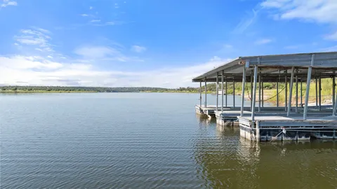 a view of a lake with a table and chairs