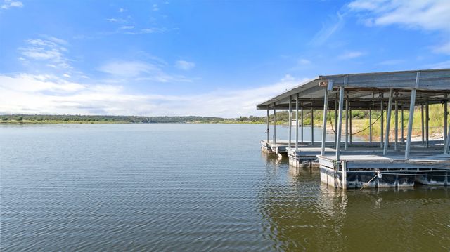 a view of a lake with a table and chairs