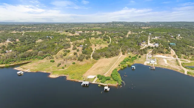 a view of a lake with houses in the back