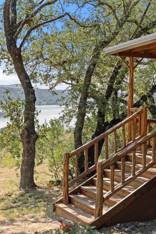 111 Swift Water Road Marble Falls, TX 78654 - Photo 23 of 37 a view of a wooden deck with large trees