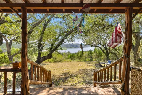 a living room with furniture and a refrigerator