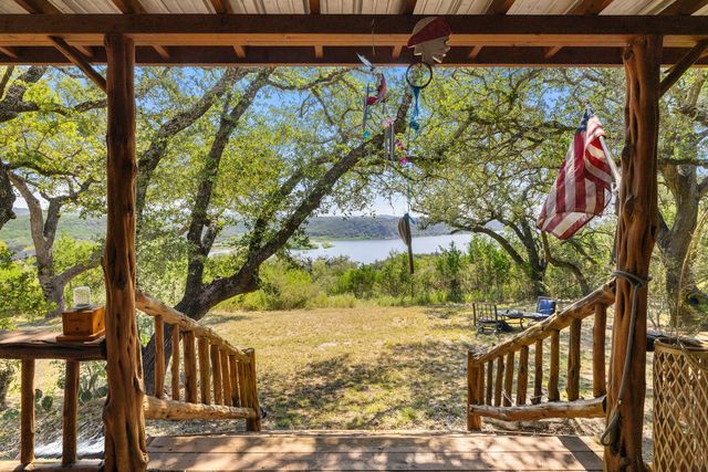 a living room with furniture and a refrigerator
