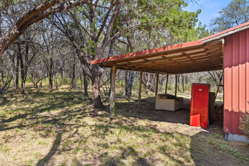 111 Swift Water Road Marble Falls, TX 78654 - Photo 35 of 37 a view of a backyard with table and chairs under an umbrella
