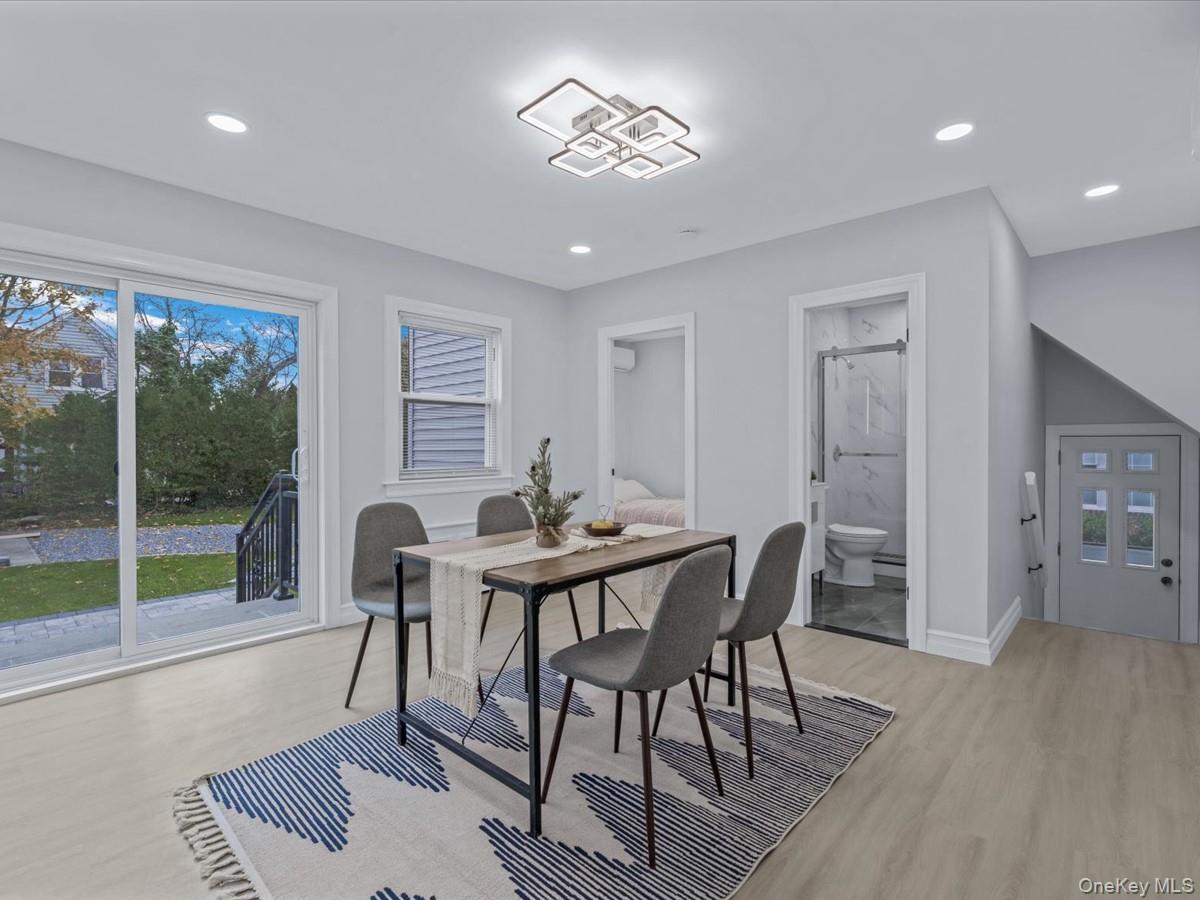 62 Essex Road Great Neck, NY 11023 - Photo 11 of 25 a view of a dining room with furniture window and wooden floor