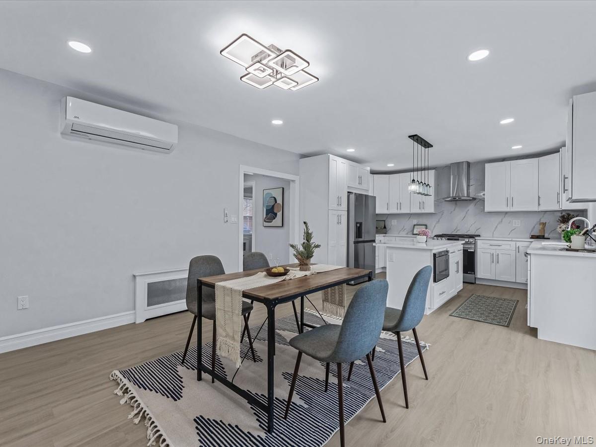 62 Essex Road Great Neck, NY 11023 - Photo 12 of 25 a view of a dining room with furniture and wooden floor