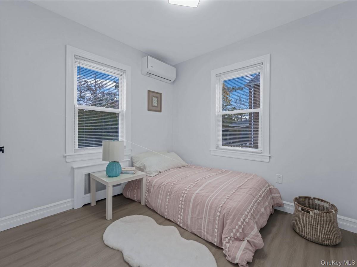 62 Essex Road Great Neck, NY 11023 - Photo 13 of 25 a bedroom with a bed and a window
