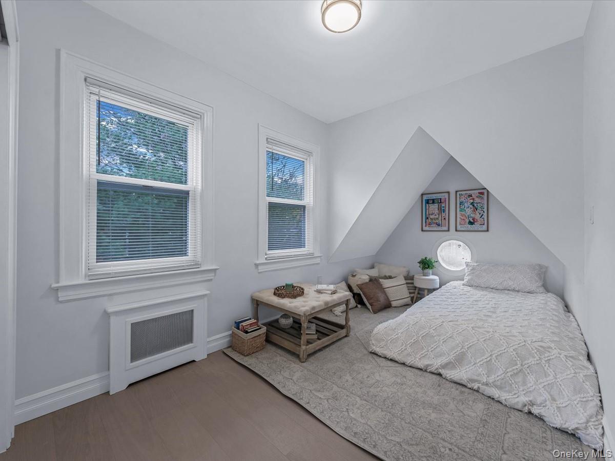 62 Essex Road Great Neck, NY 11023 - Photo 18 of 25 a bedroom with furniture and a window
